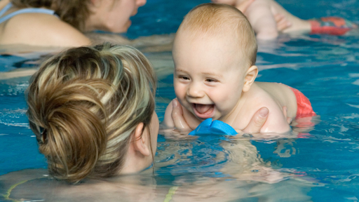 Baby in as swimming pool with mother