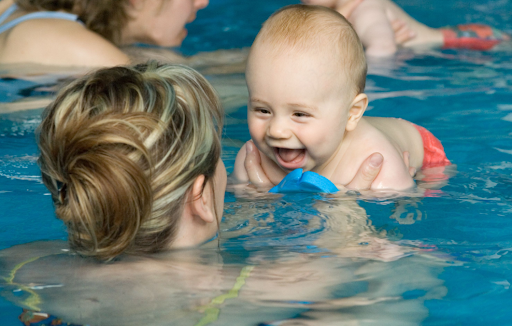 Baby in as swimming pool with mother
