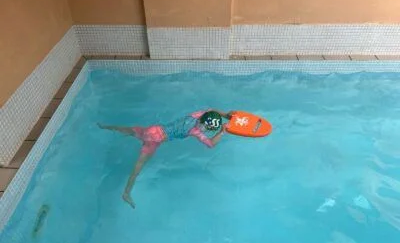 Swimming Journey Stage 4 - Stage 4 pupil practising swim technique with float
